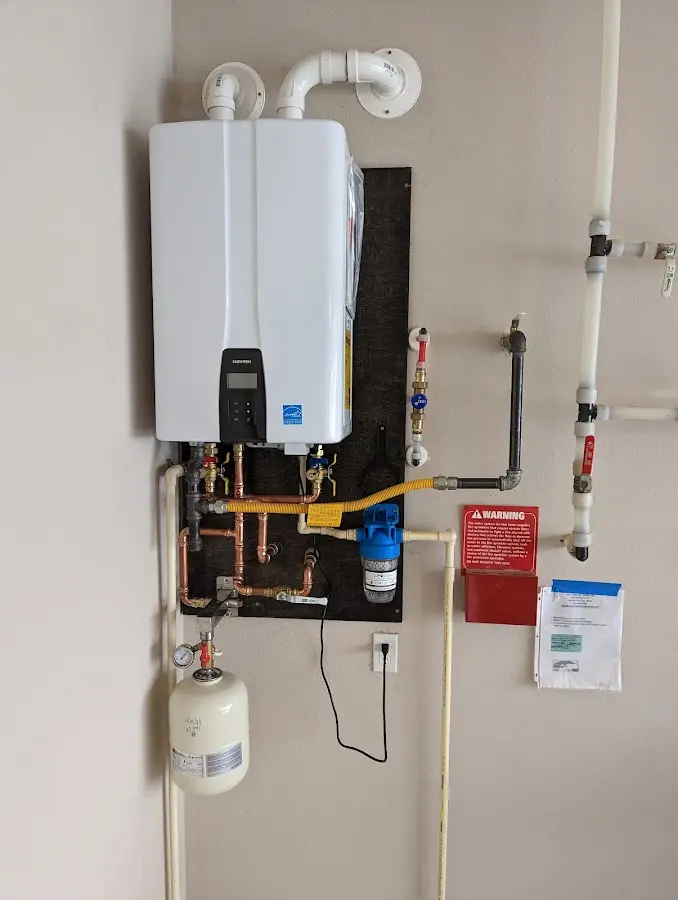 Professional plumber installing copper piping in a White Center home